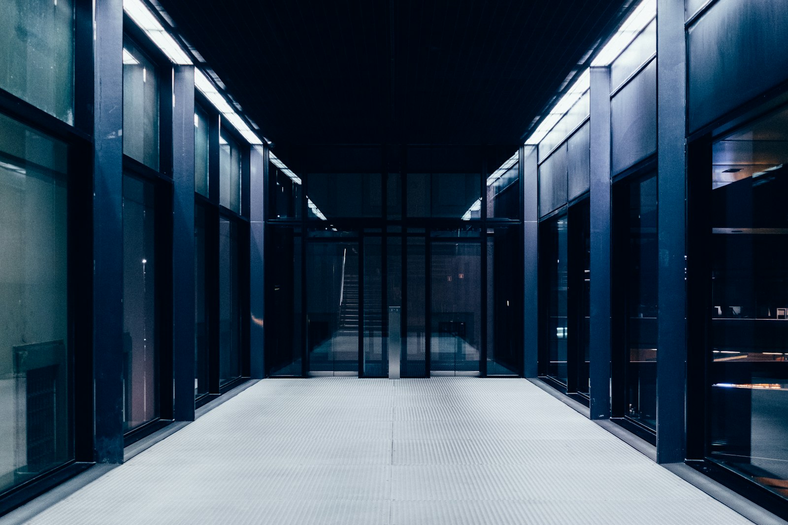 A long datacenter corridor with glass doors — the kind of facility SOC 2 controls describe on paper.