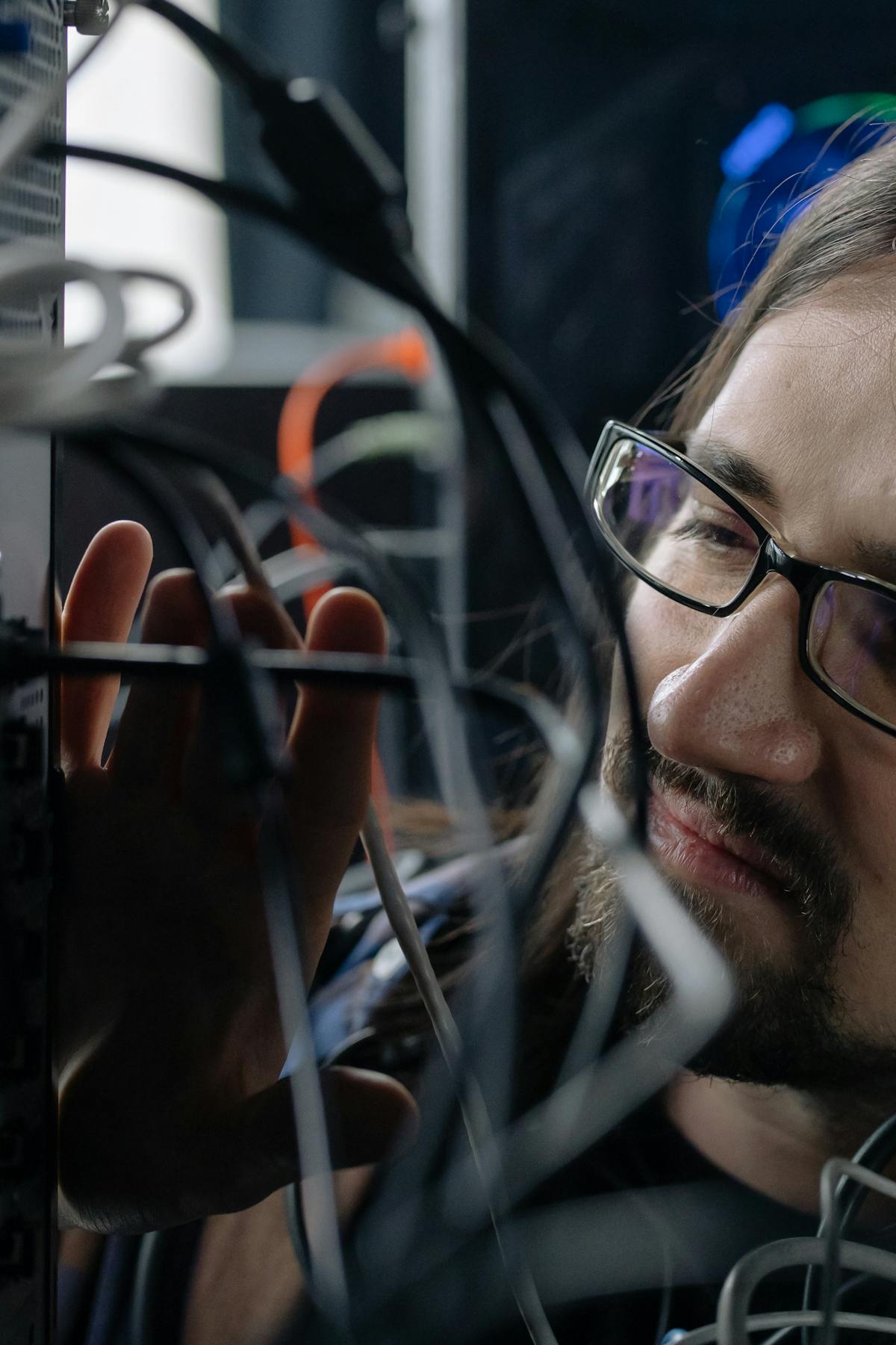 A Phoenix engineer working hands-on with server-room cabling